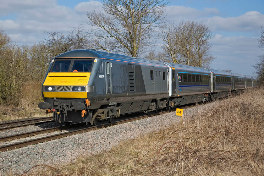 82303, CH 09.10 Kidderminster-London Marylebone, King's Sutton SP486377 
 DVT 82303 leads the 09.10 Kidderminster to Marylebone Chiltern service just north of King's Sutton. At eighty-four miles from London Paddington this location is just in Northamptonshire with the county boundary following the River Cherwell that flows parallel to the line just behind the trees to the left. 
 Keywords: 82303 09.10 Kidderminster-London Marylebone King's Sutton SP486377 DVT