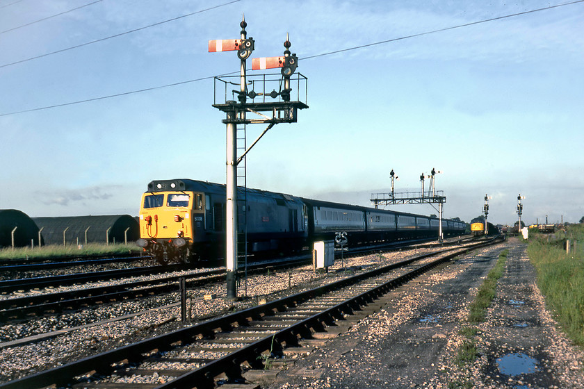 50018, 16.52 London Paddington-Newton Abbot (1B20), Fairwater Yard 
 I have ventured further into Fairwater Yard than I probably should have done to take this photograph! 50018 'Resolution' is seen passing under Silk Mill Junction's three doll home gantry leading the 1B20 16.52 Paddington to Newton Abbot service. Unfortunately, I am on the wrong side of the train for the sun at this time in the evening but the up twin doll bracket that permits access to Fairwater Yard is beautifully illuminated, dominating the centre of the scene. Notice 45048 in the background waiting to leave the yard with a down MoD train. 
 Keywords: 50018 Resolution 16.52 London Paddington-Newton Abbot 1B20 Fairwater Yard 45048