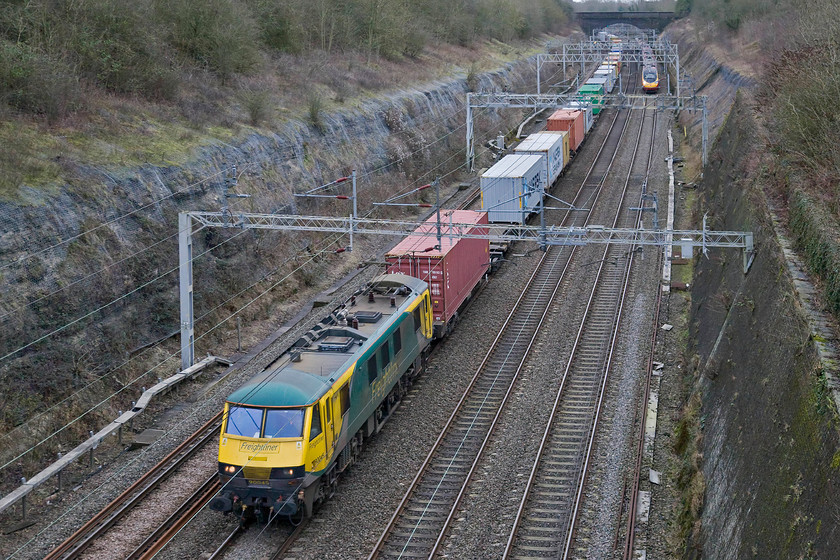 90045, 09.20 Felixstowe North-Crewe Basford Hall (4M87), Roade cutting 
 FREIGHT NUMBER TWO - subsequently numbered to the last freight observed in Roade cutting 90045 leads the 09.20 Felixstowe to Basford Hall Freightliner. A Virgin Pendolino is about to race past the slow-moving freight as it also heads north on the down fast line. 
 Keywords: 90045 09.20 Felixstowe North-Crewe Basford Hall 4M87 Roade cutting Freightliner