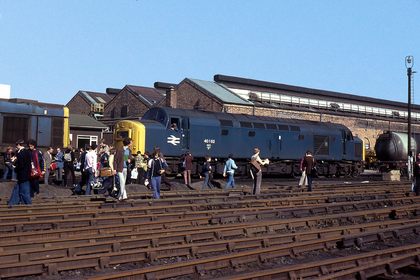 20033 & 40162 awaiting attention, Crewe Works 
 Dominating this photograph at Crewe Works is 40162. It had arrived at the beginning of August for main generator repairs. It remained on the works until February 1980, repairs during this era seemed to take an age. In addition, the work completed did not appear to have been a great success as six months after release to traffic it was back again with the same malaise! Just poking its nose into the left-hand side of the image is, according to my notes, accident damaged 20033. If this is correct, then this class 20 had been withdrawn since November 1977. It languished on at Crewe Works until January 1980 where it was cut up. However, I am not so sure as contemporary photographs have it cut-up by this time, confirmation, anybody? 
 Keywords: 20033 40162 Crewe Works