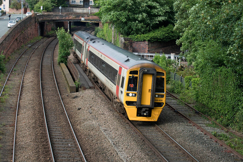 158836, AW 15.38 Holyhead-Birmingham International (1I26, 3L), Bonewaldesthorne's Tower Chester city wall 
 Having run into Chester station the 15.38 Holyhead to Birmingham International is seen again retracing its steps at least as far as Saltney Junction where it will head southwards towards Wrexham and Shrewsbury. I have only one previous photograph of 158836 taken many years ago at Bayston Hill south of Shrewsbury. In this view, taken from Chester's city wall, the train is seen crossing the Shropshire Union Canal with the first of a steep flight of locks visible to the right. 
 Keywords: 158836 15.38 Holyhead-Birmingham International 1I26 Bonewaldesthorne's Tower Chester city wall Transport for Wales