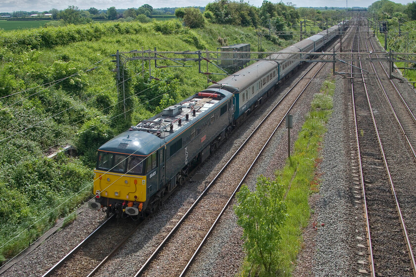 86401, 08.41 Manchester Piccadilly-Wembley Central (1Z84, 1E), Victoria bridge 
 Bringing up the rear of the 08.41 Manchester Piccadilly to Wembley Central footex charter 86401' Mons Meg' is seen passing Victoia bridge between Roade and Ashton. Out of sight at the front 86259 'Peter Pan/Les Roass' is leading the train. With the FA Cup being an all-Manchester affair for only the second time in history I am intrigued as to how the train was marshalled. In the modern age of football were fans mixing quite happily throughout or were parts of the train allocated to either United or City fans; advice, please. In a surprise result, United were the winners beating their City rivals 2-1. 
 Keywords: 86401 08.41 Manchester Piccadilly-Wembley Central 1Z84 Victoria bridge Mons Meg AL6