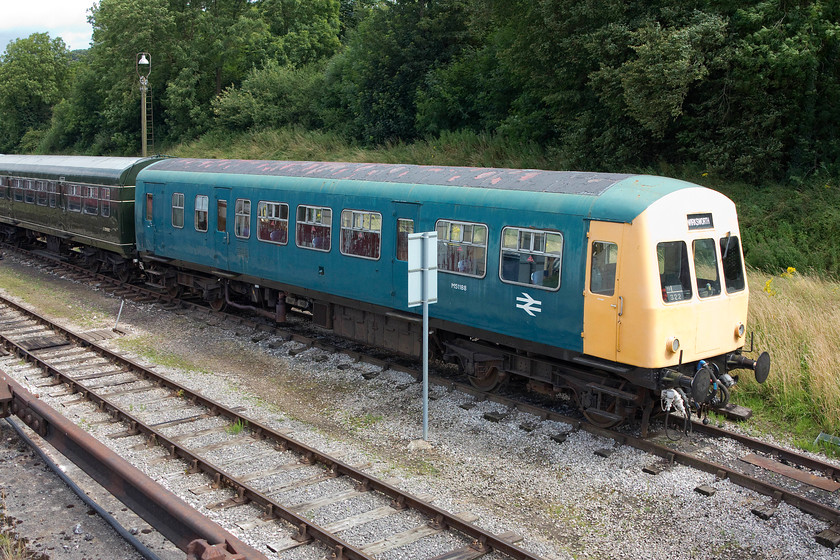 E59303 & M51188, stabled, Wirksworth yard 
 This class 101 DMU E51188, looks a little faded as it stands in Wirksworth's yard. It was delivered new in 1959 and following a working career that found it from Glasgow, to Birmingham to the north west it was withdrawn in 2001. This made it one of the very last first generation DMUs to be in service. It has been kept at various locations on the preserved network and is privately owned but in the care of Railcar Enterprises. 
 Keywords: E59303 M51188 Wirksworth yard