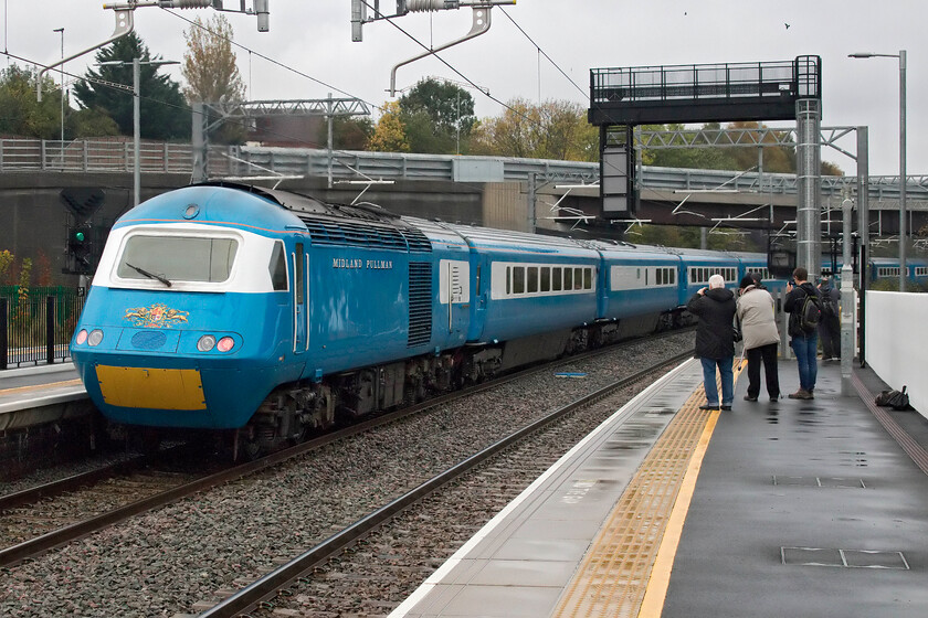 43055, outward leg of The Royal Highland Pullman, 07.39 London St. Pancras-Inverness (1Z90, RT), Wellingborough station 
 43055 powers the rear of The Royal Highland Pullman away from Wellingborough station having taken on some passengers and their bags looking forward to an extended trip to Scotland. Running as 1Z90 the train left St. Pancras just about an hour previously and would terminate on-time at Inverness in the early evening. Despite the dull conditions, the shine from the superb paintwork of the nanking blue HST was incredible testament to the excellent work of staff at Arlington's in Eastleigh. 
 Keywords: 43055 The Royal Highland Pullman 07.39 London St. Pancras-Inverness 1Z90 Wellingborough station Midland Pullman HST