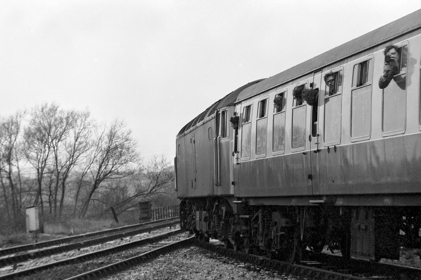 47069, outward leg of The Pines Express, 07.48 London Paddington-Weymouth (via Bristol & various freight lines), Bradford North Junction 
 47069 takes The Pines Express railtour over Bradford North Junction in Wiltshire. The train is coming off the now removed spur that linked the Chippenham to Trowbridge line northwards to the Avon Valley line. The train is about to cross the River Avon as it will do a number of times on its way to Bristol. Notice the enthusiast leaning out of the window to the right filming events on what was probably a super 8 cine camera; I wonder if the recording still exists in somebody's archive? 
 Keywords: 47069 The Pines Express 07.48 London Paddington-Weymouth Bradford North Junction