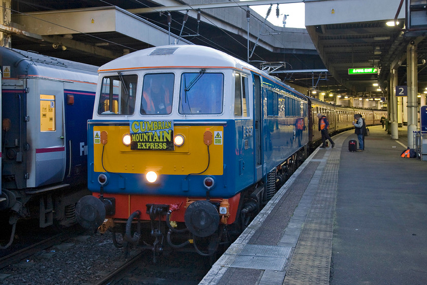 86259, outward leg of The Winter Cumbrian Mountain Express, 07.09 London Euston-Carlisle (1Z86), Euston London station 
 With various crew members going about their business preparing The Winter Cumbrian Mountain Express charter as it stands in Euston's platform two. With the stock having been dragged in from West Coast Rail's Southall depot 86259 'Les Ross/Peter Pan' made the short journey from Willesden depot. The train will soon leave at 07.09 as the 1Z86 to Carlisle with Black 5 46115 'Scots Guardsman' tasking over the train from Carnforth. 
 Keywords: 86259 The Winter Cumbrian Mountain Express 07.09 London Euston-Carlisle 1Z86 Euston London station Les Ross Peter Pan