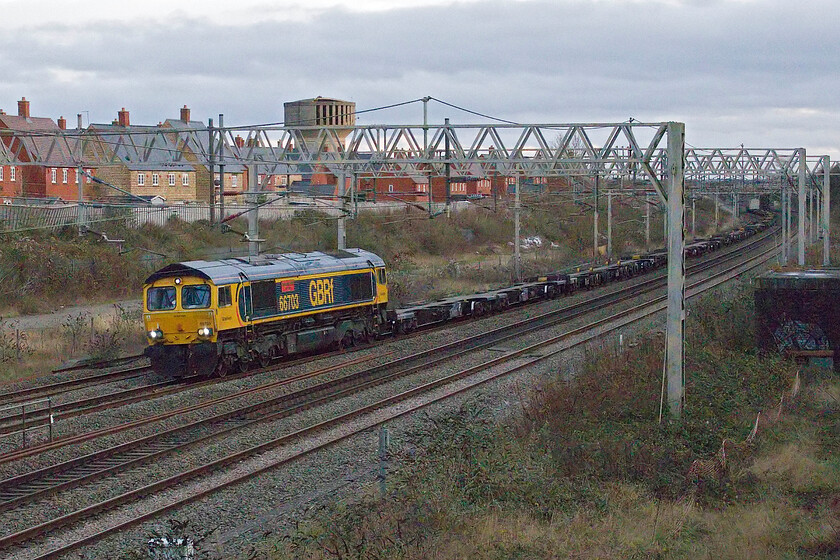 66703, 12.36 Wembley Yard-Hams Hall (4G13, 70L), site of Roade station 
 In very poor late afternoon lighting 66703 'Doncaster PSB' passes Roade leading the Sunday's 4g13 12.36 Wembley Yard to Hams Hall GBRf service. As is usual with this train, it is largely composed of empty Freightliner wagons with just one box towards the rear. 
 Keywords: 66703 12.36 Wembley Yard-Hams Hall 4G13 site of Roade station Doncaster PSB