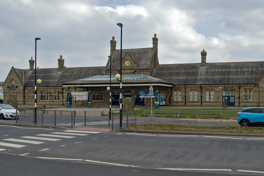 Frontage, Morecambe station with new MG as per 27.10.85 
 Okay, I admit it, this photograph has been doctored! However, it's in a good cause as I have attempted to replicate a photograph that I took on an earlier visit to Morecambe in October 1985. Almost forty years ago the station was still in use and had a car park at the front. In the car park, I parked my parents' Triumph Dolomite (RLJ 767X) in a roughly similar position to where I have Photoshopped my new MG4, seen to the right, that I have just collected from a local dealership. The original photograph from 1985 has not been processed and uploaded as yet but when it is, a link will be placed here. 
 Keywords: Frontage Morecambe station with new MG as per 27.10.85