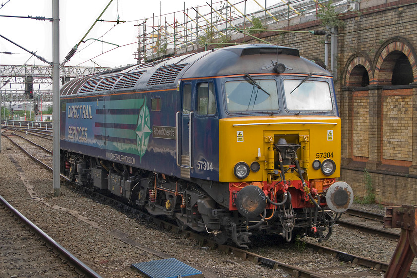 57304, stabled, Crewe station 
 57304 'Pride of Cheshire' sits at Crewe waiting for the 'phone call to come through! It is a thunderbird ready to rescue a stricken train should it fail and block the busy mainline. This is a rare occurrence but one that can cause absolute chaos if not dealt with quickly. 57304 was photographed by me in a very different guise as steam-heat 47055 thirty-seven years previously, see..... https://www.ontheupfast.com/v/photos/21936chg/25511222404/x47055-parcels-bradford-avon-foot 
 Keywords: 57304 stabled Crewe station