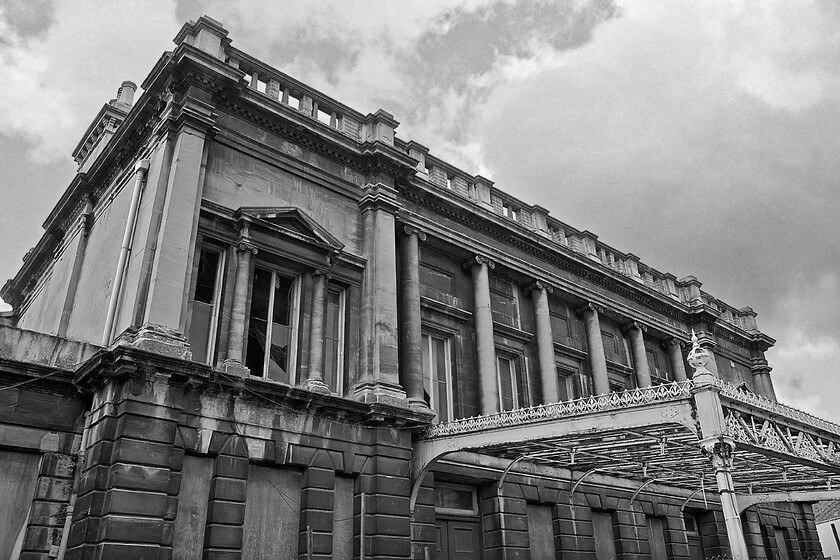 Frontage, Bath Green Park station 
 The frontage of Bath Green Park station was built using locally mined Bath stone (oolitic limestone) and designed to copy the fine Georgian architecture of the city. Notice the six ionic columns that dominate the front of the perfectly symmetrical frontage along with the rooftop balustrade. When the station came into use in 1870, it gained the name Bath Queen Square station but locally it was known as the Midland Station. 
 Keywords: Frontage Bath Green Park station