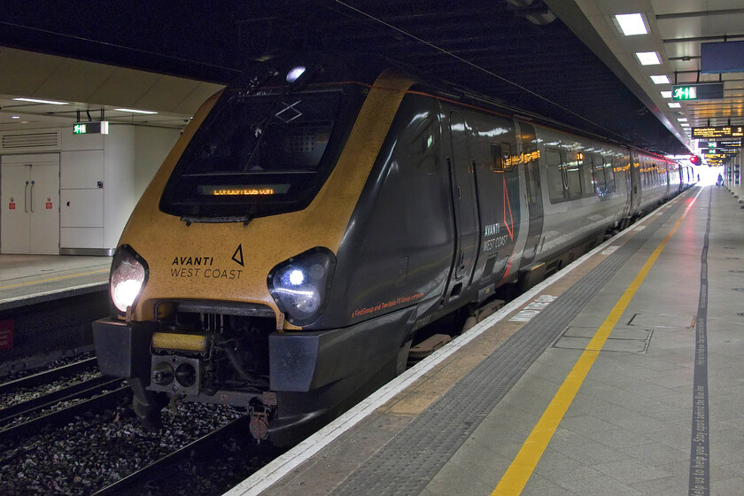 221103 & 221102, VT 18.30 Birmingham New Street-London Euston (1B80, 4L), Birmingham New Street station 
 Consecutively numbered Voyagers 221103 and 221103 stand in the gloom at Birmingham New Street waiting to work the 18.30 departure to Euston. Andy and I took this Avanti West Coast service as far as Rugby making it the penultimate journey of our tour of the West Midlands. Whilst a trip on a Voyager brings its customary noise and vibration, made worse according to where one chooses a seat Andy did comment on how fast it felt particularly when accelerating. The quality of the onboard announcements was the best of the day with succinct and accurate information made at the appropriate times with no mention of the dreaded 'station stops' or the infuriatingly tautological 'final destination'!

Journey score 9/10 
 Keywords: 221103 221102 18.30 Birmingham New Street-London Euston 1B80 Birmingham New Street station Avanti West Coast