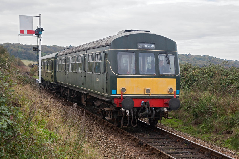 M56352 & M51192, 10.35 Holt-Sheringham, Weybourne TG122424 
 M56352 and M51192 leave Weybourne and descend down towards Sheringham with the 10.35 from Holt. The DMU is just passing Weybourne's home signal. Unlike the others within the confines of the station area, this one is a standard enamelled steel upper quadrant. Notice that it has a route describer underneath making clear to the driver what platform the train is pathed into. 
 Keywords: M56352 M51192 10.35 Holt-Sheringham Weybourne TG122424