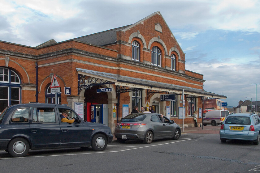 Frontage, Salisbury station 
 The rather grand frontage of Salisbury station dates from 1901 being a later replacement for the smaller station that is out of sight behind the double-decker bus to the right of the image. It has changed very little from when I took a very similar image back in 1981 but the taxis on view have, see.... https://www.ontheupfast.com/p/21936chg/30035687493/frontage-salisbury-station 
 Keywords: Frontage Salisbury station