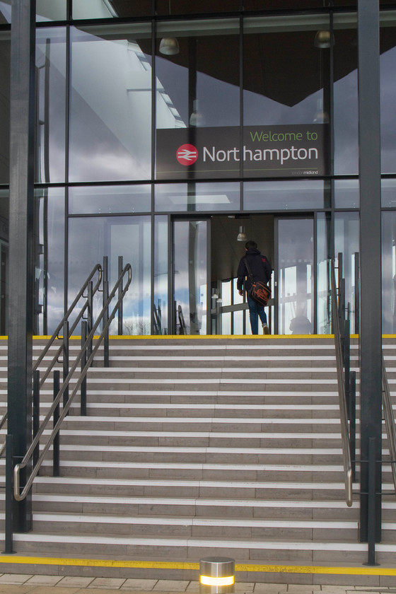 Main entrance, Northampton station 
 This was my first visit to Northampton's new station that had been opened just two weeks earlier replacing the 1966 built structure. This is the new entrance from Westbridge with step-free access from the car park on the other side of the building. Facilities are reasonable with a small WH Smiths and two coffee chains, one on the ground floor and one just at the top of the steps seen here. 
 Keywords: Main entrance Northampton station