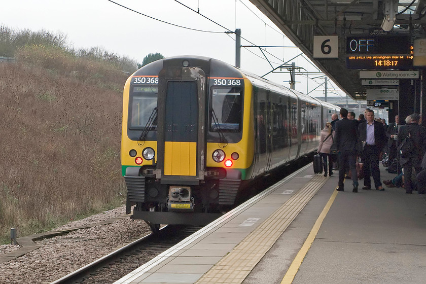 350368, LM 13.46 London Euston-Crewe (1U37), Milton Keynes station 
 It appears that many passengers heading north at Milton Keynes are waiting for a Virgin service rather than taking a London Midland Desiro. 350368 gets away from platform six (the down fast line) working the 13.46 Euston to Crewe service. 
 Keywords: 350368 13.46 London Euston-Crewe 1U37 Milton Keynes station London Midland Desiro