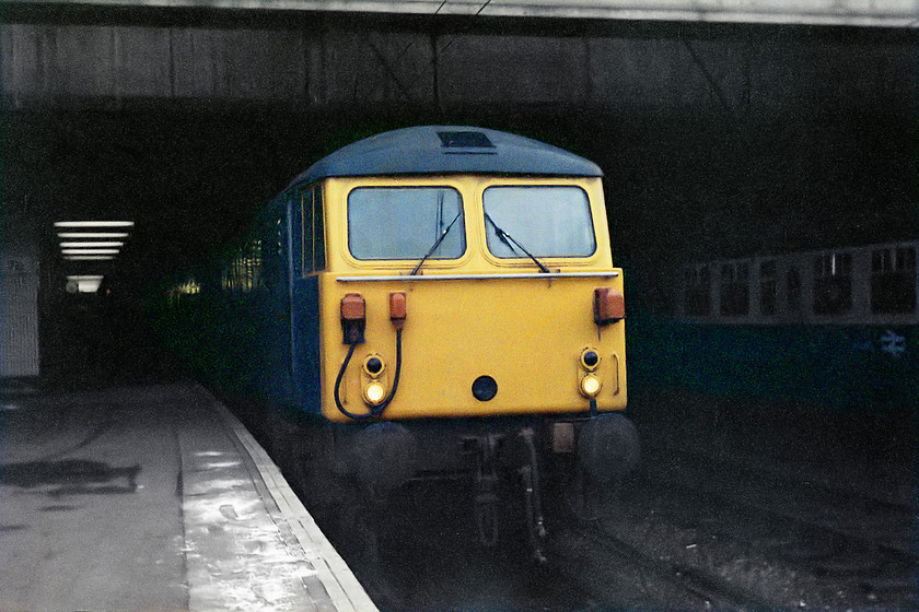 87006, unidentified down working, Birmingham New Street station 
 87006 pokes its nose out from the gloom at Birmingham's New Street station. We travelled behind this engine from Birmingham to Crewe. This was my first 87 haulage and I remember being quite excited about it! 87006 was regular perform on the WCML right up to 2008/9 when it became one of those selected for export to Bulgaria. 
 Keywords: 87006 Birmingham New Street Bulgaria