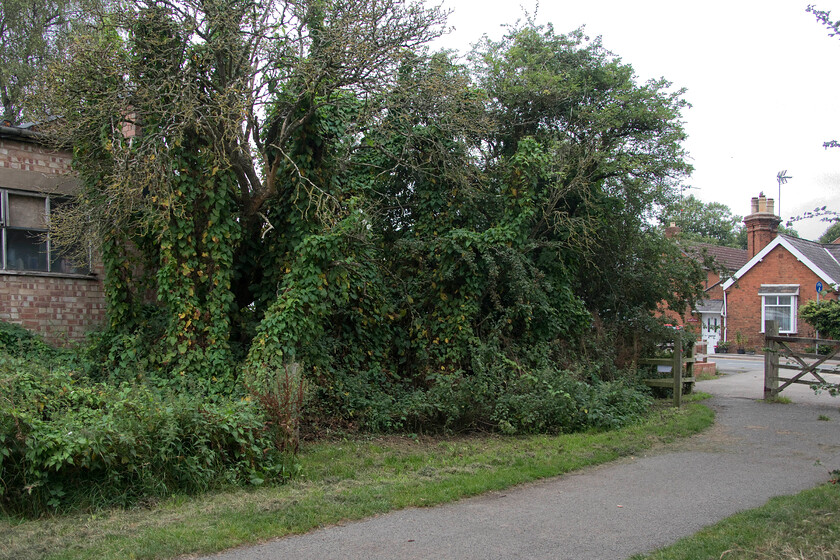 Site of Little Bowden signal box 
 With the northern end and termination of the Brampton Valley Way in the foreground the former level crossing of the Northampton to Market Harborough line is seen beyond the gate. The trees in the centre mark the site of the former Little Bowden signal box that I photographed back in 1980 standing in a very similar position, see.... https://www.ontheupfast.com/p/21936chg/29672750004/little-bowden-crossing-signal-box 
 Keywords: Site of Little Bowden signal box