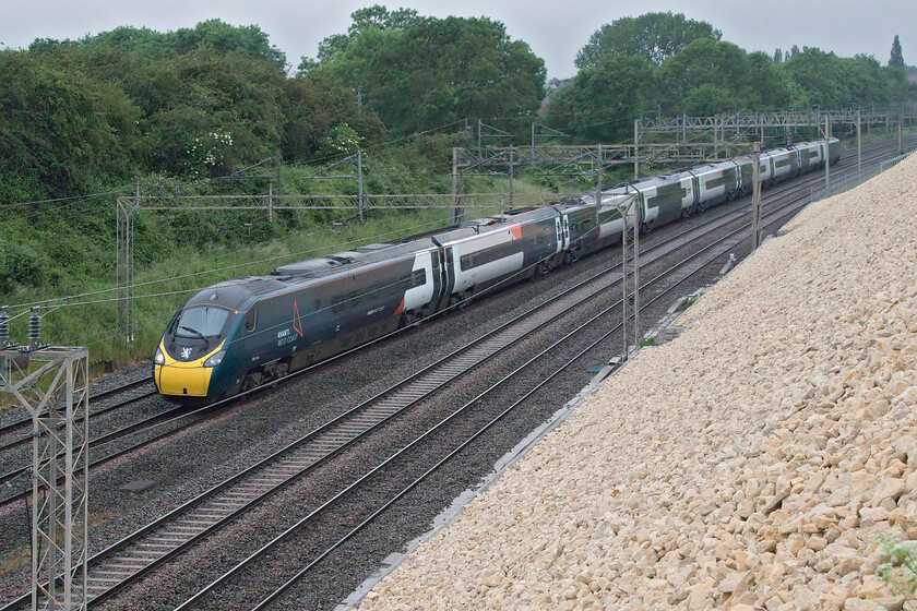 390044, VT 16.00 Glasgow Central-London Euston (1Z25, 11E), Ashton Road bridge 
 Having failed by a paltry twenty-one seconds to break the London to Glasgow time record, 390044 'Royal Scot' heads back south as the 16.00 Glasgow to Euston 1Z25. The attempt failed due to two 'unforeseen' TSRs, one at Carstairs and another just a few miles from its destination. Quite how Network Rail who had 'cleared the lines' in order to attempt the record had not spotted this issue is beyond me; I'm sure in the fullness of time this will come out. The Pendolino was re-named following a short ceremony at Euston prior to departure and carries a rampant lion from the Royal Banner of Scotland that should really be in red rather than white. 
 Keywords: 390044 16.00 Glasgow Central-London Euston 1Z25 Ashton Road bridge Royal Scot