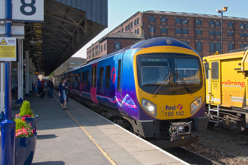 185142, TP 10.06 Manchester Airport-York (1P24), Huddersfield station 
 Having alighted from the 09.22 Liverpool to Scarborough TPE service at Huddersfield we had missed our connecting train to Bradford via Halifax. With no other train due for some time, station staff suggested that we caught the following TPE 10.06 Manchester Airport to York service as far as Leeds. We would then have to double back to Bradford alighting at Forster Square rather than Exchange as was planned. 185142 arrives at Huddersfield that was to be our fourth train of the day from Northampton to Bradford. 
 Keywords: 185142 10.06 Manchester Airport-York 1P24 Huddersfield station TPE Transpennine Express