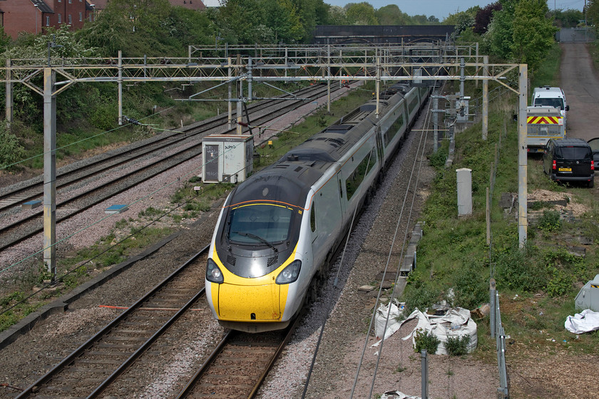 390126, VT 07.37 Glasgow Central-London Euston (1M08, 6E), site of Roade station 
 On the up slow line and having taken the Northampton line, 390126 emerges from Roade cutting working the 07.37 Glasgow Central to Euston. Just out of sight to the left were a small number of Network Rail track workers involved in tree and vegetation clearance on the embankment. This has been much needed for some time with it brushing the sides of passing trains such was its rampant growth since the last bout of clearance some years ago. 
 Keywords: 390126 07.37 Glasgow Central-London Euston 1M08 site of Roade station Avanti West Coast