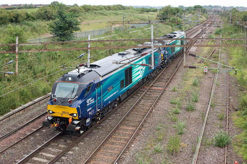 68019 & 68009, 06.50 Crewe Gresty Bridge-Wembley LEs, Mill Lane bridge, Northampton 
 68019 'Brutus' and 68009 'Titan' approach Northampton from the north as the 06.50 Gresty Bridge to Wembley light engine move. They are about to pass under Mill Lane bridge that carries the road that links the Kingsthorpe and Dallington parts of the town together. This section of track was once firmly quadruple as just beyond the shot is where the much missed Market Harborough link line left the deviation also being where Northampton No.5 signal box was located. Many rue the day that this line closed as today it would prove to be very useful indeed. 
 Keywords: 68019 68009 06.50 Crewe Gresty Bridge-Wembley Mill Lane bridge Northampton