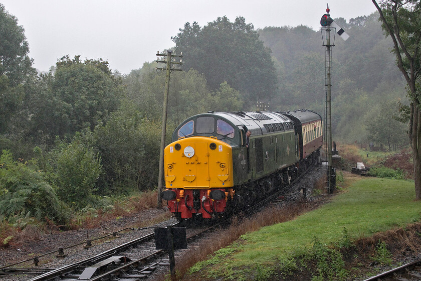 40106, 14.45 Kidderminster-Bridgnorth, approaching Highley 
 With the rain coming down like stair rods the driver of 40106 'Atlantic Conveyor' peers from his cab window on the approach to Highley station no doubt getting a soaking! The Whistler is leading the 14.45 Kidderminster to Bridgnorth service that Andy and I were about to take just one stop to Hampton Loade. Not being regular attendees of galas and travellers on charters both Andy and myself were unable to recall the last time that we had haulage behind a Class 40 even if it was for a relatively short distance. The short section of line in the foreground allows locomotive access to and from the superb Highley Engine House museum. 
 Keywords: 40106 14.45 Kidderminster-Bridgnorth approaching Highley Atlantic Conveyor