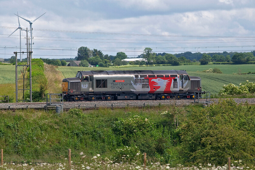 37800, 11.58 Wembley HS-Derby RTC (0M57, 5L), Roade Hill 
 I had been tracking the progress of the 0M57 on my phone for some time leaving home to photograph it at my chosen location as it was passing Cheddington. As it was a light engine and that a bit of sun was a possibility I decided that it would be a good idea to revisit this spot on Roade Hill. Whilst the alpacas were not in their field in the foreground that would create a little extra interest 37800 'Cassiopeia' certainly makes up for it operating the 11.58 Wembley to Derby RTC light engine move. Close examination of the photograph reveals that the driver is leaning out of the window and that he appears to be looking straight at me. 
 Keywords: 37800 11.58 Wembley HS-Derby RTC 0M57 Roade Hill Cassiopeia ROG Rail Operations Group