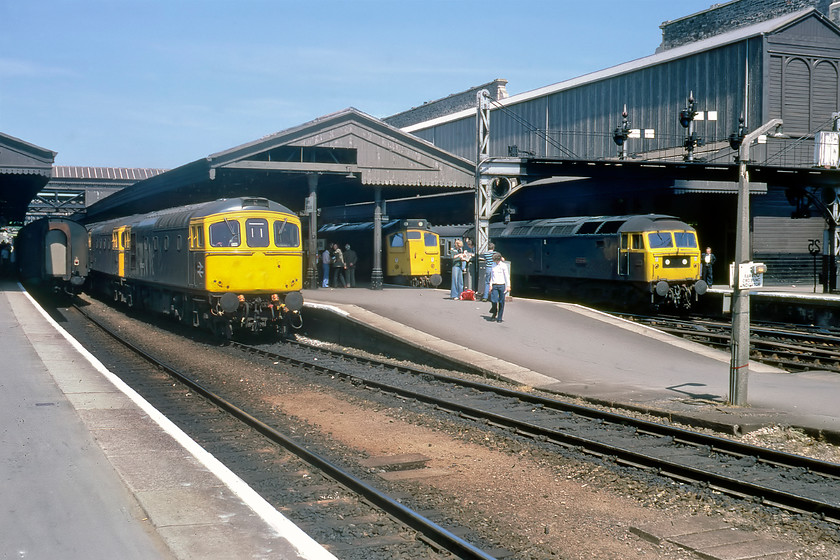 33027 & 33042, 13.40 Exeter St. David's-Brighton, 25058, ECS & 47090, 10.27 London Paddington-Paignton, Exeter St. David's station 
 With spotters gathering at their usual haunt just above the platform ramp at Exeter St. David's a busy scene is in view with all of the platforms occupied by trains. 47090 'Vulcan' has just arrived leading the 10.27 Paddington to Paignton express service and will soon be on its way. Next to the Class 47 is Type 2 25058 that has worked a train in from Barnstaple. Soon it will run round its stock and head back whence it came. The pair of 33s, 33027 and 33043, have just run round their rake of Mk.1s and will leave soon with the 13.40 to Brighton. Last, but not least, the tail of a Mk.1 coach is seen at the rear of the 10.36 Newquay to Paddington train. Of the four locomotives in this view, only the Class 47 is still with us and running on the mainline as 47843 operated by RivieraTrains painted in the Company's own version of BR's blue and yellow livery. 25058 moved to the northwest and was named 'Castell Criccieth/Criccieth Castle'. 33027 was to become a celebrity locomotive within a few months of this date, being repainted and named 'Earl Mountbatten of Burma' following it being one of the locomotives that hauled Mountbatten's funeral train the previous year. Ironically, earlier in the day, we had travelled behind the other locomotive involved in the funeral train that had already been treated and recognised, see..... https://www.ontheupfast.com/p/21936chg/29422474804/x33008-06-53-bristol-temple-meads

There is an audio recording of this event on my youtube channel, see...https://youtu.be/-pH1wWB8WQk 
 Keywords: 33027 33042 13.40 Exeter St. David's-Brighton 25058 ECS 47090, 10.27 London Paddington-Paignton Exeter St. David's station