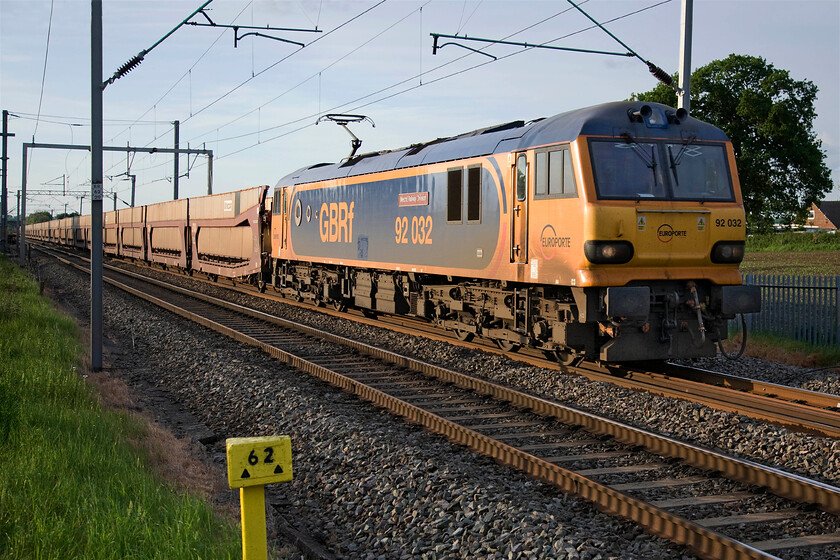 92032, 15.49 Garston-Dagenham (6L48), Milton Malsor SP740553 
 I think that the GBRf livery applied to just four Class 92s suits the class. Passing Milton Malsor, located due south of Northampton, 92032 'MechE Railway Division' leads the 15.49 Garston to Dagenham empty double-decker car wagons running as 6L68. 
 Keywords: 92032,15.49 Garston-Dagenham 6L48 Milton Malsor SP740553 MechE Railway Division