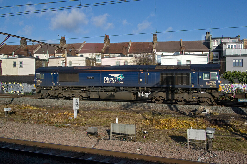 66422, 10.02 Tilbury-DIRFT (4M07, 3E), Willesden 
 As our train picked up speed through Willesden we began to pass a long rake of Freightliner wagons so I held my camera primed and hopefully in a position to capture the locomotive. Using the rapid burst mode I managed this side-on view of DRS stalwart 66422 'Max Joule 1958-1999' leading the 4M07 10.02 Tilbury to Daventry. I was at Crewe Gresty Bridge's open day back in 2022 with Mike when this locomotive was named with the honour having been passed on from 20303 when it was disposed of by DRS 
 Keywords: 66422 10.02 Tilbury-DIRFT 4M07 Willesden Max Joule 1958-1999