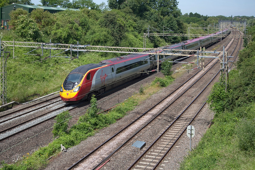 390119, VT 10.01 Preston-London Euston (1A10, 1E), Victoria Bridge 
 390119 'Virgin Warrior' forms the 10.01 Preston to London Euston 1A10 working past Victoria Bridge between Northampton and Milton Keynes. A beautiful and hot summer day that more than made up for all those cold, wet and downright miserable times that I have waited for some train or other to come along! 
 Keywords: 390119 1A10 Victoria Bridge