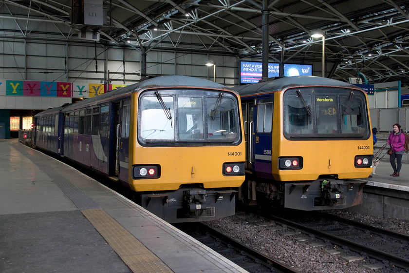 144001, stabled & 144004, NT 17.59 Leeds-Horsforth (2C62, 2L), Leeds station 
 144001 and 144004 stand side by side at Leeds station. 144001 is stabled and was not showing on RTT as working a train all evening. However, 144004 will work the 17.59 to Horsforth, a very short service of some five miles! Having said this, the train was pretty full when it left stopping at Burley Park, Headingley and Horsforth. 
 Keywords: 144001 144004 17.59 Leeds-Horsforth 2C62 Leeds station