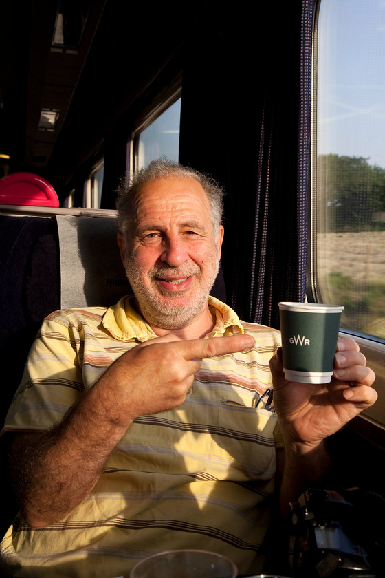 Andy, on-board the 23.45 London Paddington-Penzance Sleeper 
 My travelling companion, Andy, sits in the first class day coach enjoying his GWR breakfast coffee whilst travelling through the glorious Cornwall countryside. 
 Keywords: Andy on-board the 23.45 London Paddington-Penzance Sleeper