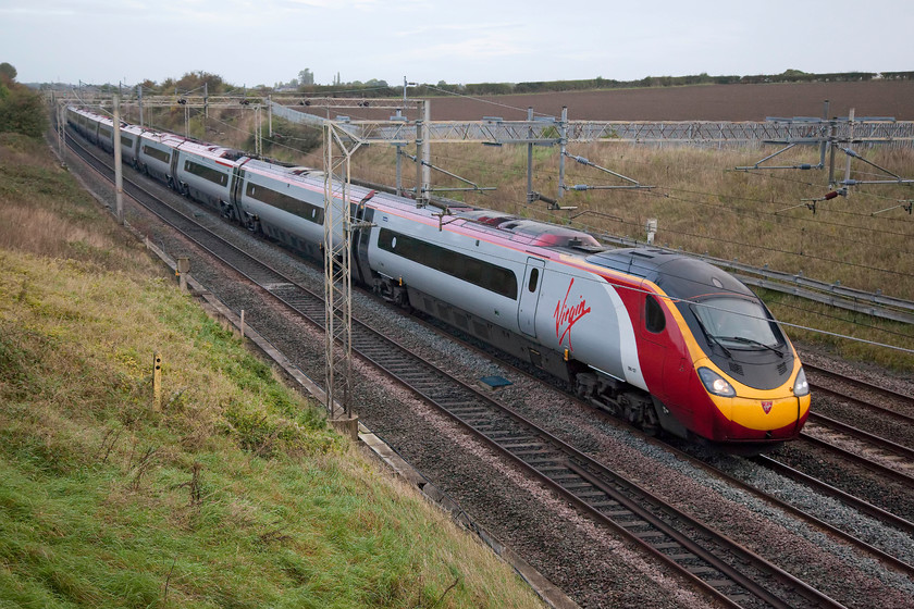 390127, VT 06.10 Manchester Piccadilly-London Euston (1A05, 3E), Castlethorpe SP790453 
 Just north of Castlethorpe that is itself is just north of Milton Keynes, is 390127 'Virgin Buccaneer'. It is heading south with the 1A05 06.10 Manchester to Euston service. 
 Keywords: 390127 06.10 Manchester Piccadilly-London Euston 1A05 Castlethorpe SP790453