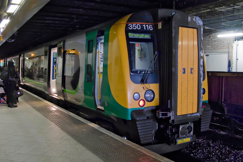 350116, LM 07.49 London Euston-Birmingham New Street (1W03), Birmingham New Street station 
 Having travelled up from Northampton aboard 350116 its stands in the darkness at Birmingham New Street. The London Midland Desiro had terminated with the 07.49 from Euston. Notice the wagons on the adjacent platform one. These are being used as part of the huge and protracted redevelopment of New Street with materials being brought in and out by rail. 
 Keywords: 350116 07.49 London Euston-Birmingham New Street 1W03 Birmingham New Street station London Midland Desiro