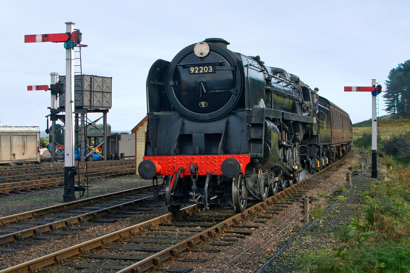 92203, 10.30 Sheringham-Holt, Weybourne station 
 Possibly representing the pinnacle of steam locomotive development is the 2-10-0 Riddles designed 9F? They were powerful and relatively efficient and able to haul extremely heavy loads for which they were designed. 92203 'Black Prince', a name it never carried during its British Railways career, arrives at Weybourne with the first service of the day, the 10.30 Sheringham to Holt. On withdrawal in 1967 after a mere nine years of working life 92203 was purchased by the wildlife artist and railway enthusiast David Shepherd who has owned it ever since. There are rumours that the locomotive is going to be purchased from him by the NNR to join their home fleet.

NB David Shepherd CBE passed away in Septemeber 2017 and indeed the NNR now owns this fine locomotive. Without the foresight and effort of people like David Shepherd, we would not enjoy many of the steam locomotives still in use today. 
 Keywords: 92203 10.30 Sheringham-Holt Weybourne station Black Prince David Shepherd