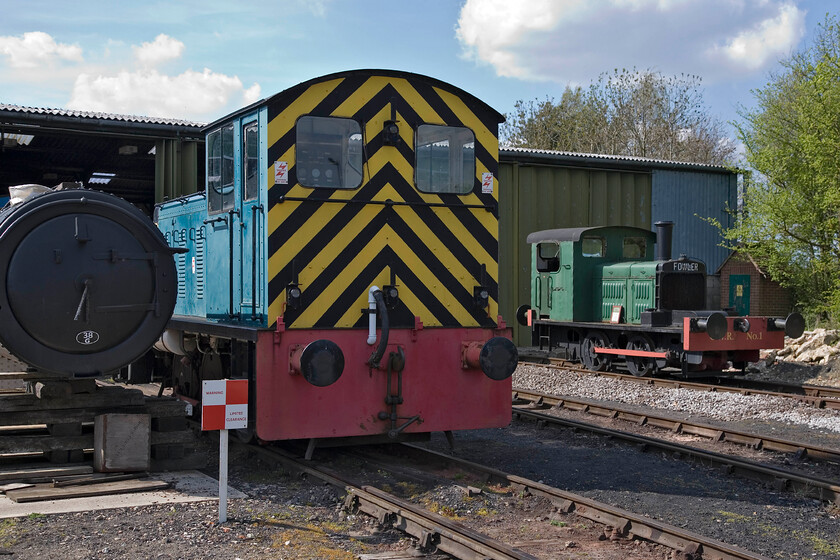 D2298 & No. 1 (20067), stabled, Quainton Road Up yard 
 Two of The Buckinghamshire Railway Centre's resident shuters sit in the pleasant afternoon sunshine. Nearest to the camera is the former BR Class 14 now numbered D2298. It had a short working life with BR of just nine years before being purchased into preservation at the fledgling Derwent Valley Light Railway. In October 1982 it arrived at Quainton, having been purchased by a QRS member where it has been an active and resident member of the QRR fleet ever since. To the right is an unusually designed Fower shunter carrying the number one but is actually correctly numbered 20067 named 'Osram' as in the manufacturer of lighting consumables. It worked for the company at its North Wembley plant for many years before being used by GEC in their yards. Finally, after retirement in 1969, it moved to Quinton Road where it has resided since. 
 Keywords: D2298 No. 1 stabled Quainton Road Up yard BR Drewry 0-6-0 Class 14 Fowler 0-4-0 diesel shunter.