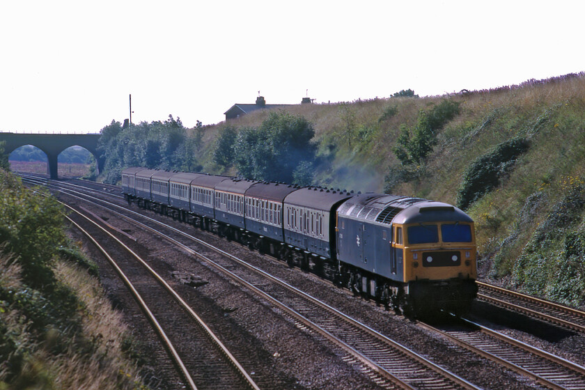 47457, 08.30 London King's Cross-Cleethorpes (1D01), Essendine TF043129 
 Taken against the sunshine at Essendine 47457 (I believe) leads the 1D01 08.30 Kings Cross to Cleethorpes service. I had positioned myself for this train as it was often Deltic hauled but I was to be disappointed on this day but I am glad that I pressed the shutter on my Pentax ME Super capturing this scene that itself is now historical. On this day I did not manage to get the number of the Class 47 as it passed me but using The Bashing Years website revealed that 47457 worked the balancing 13.20 1A21 Cleethorpes to Kings Cross later so I deduced this was, in all likelihood, the locomotive in this photograph. 
 Keywords: 47457 08.30 London King's Cross-Cleethorpes 1D01 Essendine TF043129