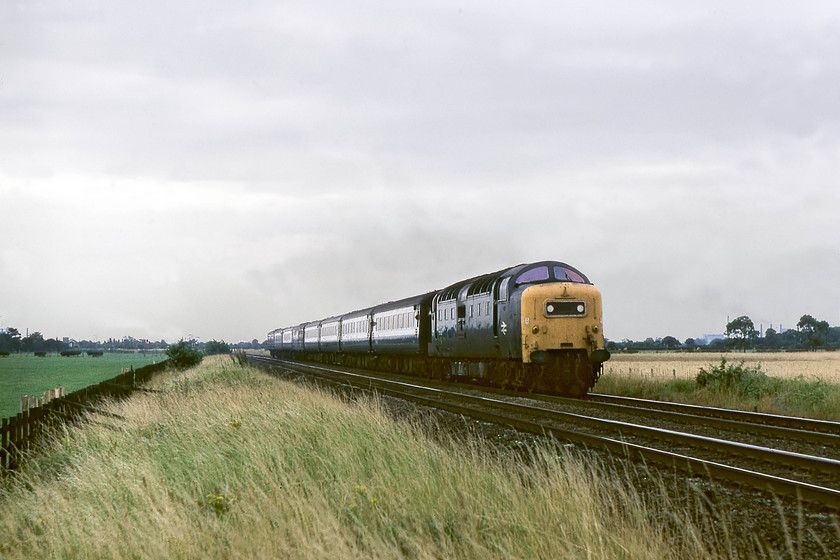 55008, 14.05 London King`s Cross-York (1L43), Norwell Lane crossing 
 55008 'The Green Howards' heads northwards with the 14.05 King's Cross to York 'fast' service. The train is seen just north of Newark at Norwell Lane level crossing. This view is still available today with the complete absence of trackside growth in the intervening forty years! However, a picture is tricky as there is a hut, some electric boxes, the wiring, and the blessed palisade fencing all to contend with! 
 Keywords: 55008 14.05 London King`s Cross-York 1L43 Norwell Lane crossing