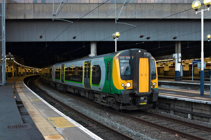 350109, LM 19.24 London Euston-Milton Keynes Central (2K13, 2L), London Euston station 
 350109 leaves the interior gloom of Euston into the early spring evening with the 19.24 to Milton Keynes Central. I always wonder why Milton Keynes station has become 'Central'. There are no other stations (or proposals to build any) so why such an grandiose name? Thoughts on a postcard please? 
 Keywords: 350109 2K13 London Euston station