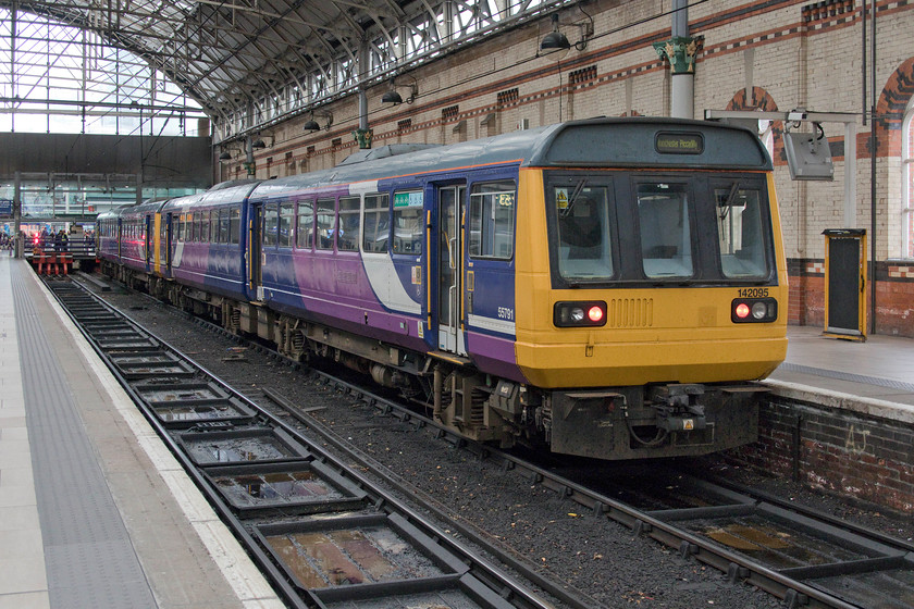 142095 & 142096, stabled, Manchester Piccadilly station 
 A scene soon to disappear from Manchester Piccadilly, and all stations for that matter, over the coming few months. Consecutively numbered 142095 and 142096 are seen stabled at Piccailly's platform one. Despite some searching on RTT I could not identify when they worked in or when they were to work out again. Platforms one and two were synonymous with the Woodhead route being electrified using the 1500v DC overhead system. This situation continued until 1984, despite the closure of the Woodhead route in 1981, as local services to Glossop and Hadfield still used DC stock in the form of the class 507 units. 
 Keywords: 142095 142096 stabled Manchester Piccadilly station Pacer