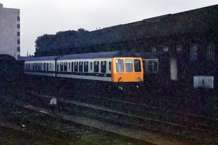 Class 108, refurbished, Gloucester Horton Road 
 A refurbished class 108 DMU is seen stabled at Gloucester Horton Road. This livery was not particularly practical and must have been a devil to keep clean. However, it has made it possible to produce this image, if had been the in the usual Rail Blue it would not have stood out in the gathering murk!