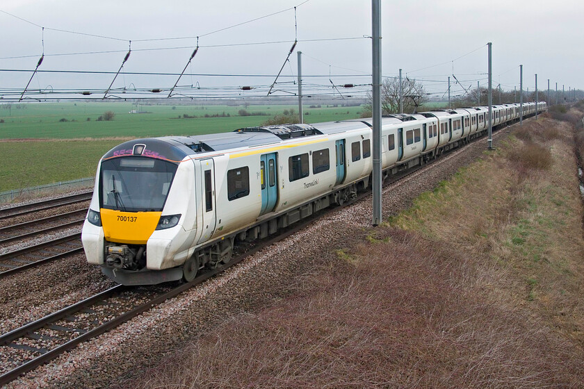 700137, TL 07.54 Peterborough-London KIng's Cross (1P15, 1E), Sandy TL176510 
 Our final train observed at New Zealand bridge near Sandy is another Thameslink Class 700 with graffiti applied in the same place as all the others seem to. 700137 heads south working the 1P15 07.54 Peterborough to Kings Cross service that arrived slightly early into its destination probably due to the massive reduction of services due to further industrial action. 
 Keywords: 700137 07.54 Peterborough-London KIng's Cross 1P15 Sandy TL176510 Thameslink