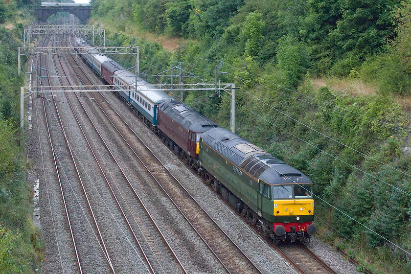 57009 & 47848, 11.23 Carnforth Steamtown-Southall WCR (5V42, 83E), Hyde Road bridge 
 The 11.23 Carnforth to Southall 5V42 empty stock move is seen passing through Roade cutting from Hyde Road bridge. More unusually, the stock is double-headed rather than being top and tailed which is normally the case. 57009 'GJ Churchward' is leading with 47848 tucked in behind. Back in the 1970s as 47079 I 'spotted' this Canton-based locomotive many times in my home area in Wiltshire and even had haulage behind it to York, see.... https://www.ontheupfast.com/p/21936chg/23615804204/x47079-west-wilts-scouts-jubilee 
 Keywords: 57009 47848 11.23 Carnforth Steamtown-Southall WCR 5V42 Hyde Road bridge GJ Churchward