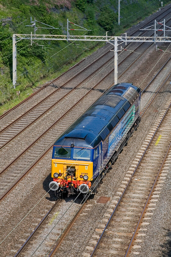 57304, 09.30 London Euston-Stafford (0Z20), Roade Cutting 
 With Virgin having outsourced their Thunderbird work to DRS the Class 57s are now seen along the length of the WCML in their new livery. DRS move the fleet around at various times throughout the week and this is the case here with 57304 'Pride of Cheshire' (formally 'Gordon Tracy') passing Roade as the 0Z20 09.30 Euston to Stafford move. With Pendolino (and Voyagers for that matter) reliability now being excellent, the Thunderbirds see little action. 
 Keywords: 57304 09.30 London Euston-Stafford 0Z20 Roade Cutting Pride of Cheshire