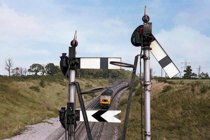 47245, unidentified London Paddington-Paignton working, Clink Road Junction 
 47245 leads a London Paddington to Paignton working past Clink Road Junctions down bracket signal. The higher of the two posts is pulled off indicating that the train will take the Frome cut-off. The signal structure itself is one of the late GWR/early British Railways tubular types painted in WR silver. Notice that the finial on the shorter post is looking a little unsteady! 
 Keywords: 47245 London Paddington-Paignton working Clink Road Junction