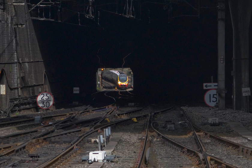 390039, VT, 14.43 London Euston-Edinburgh (9S80), from Birmingham New Sreet station 
 Looking through New Steet South tunnel from the platform end of the station, 390039 is seen working the 14.43 Euston to Edinburgh 'slow' service. I say slow, as this particular diagram goes via New Street to Crewe making a number of additional stops rather than the faster and more direct route via the Trent valley. 
 Keywords: 390039 14.43 London Euston-Edinburgh 9S80 from Birmingham New Sreet station Virgin Pendolino