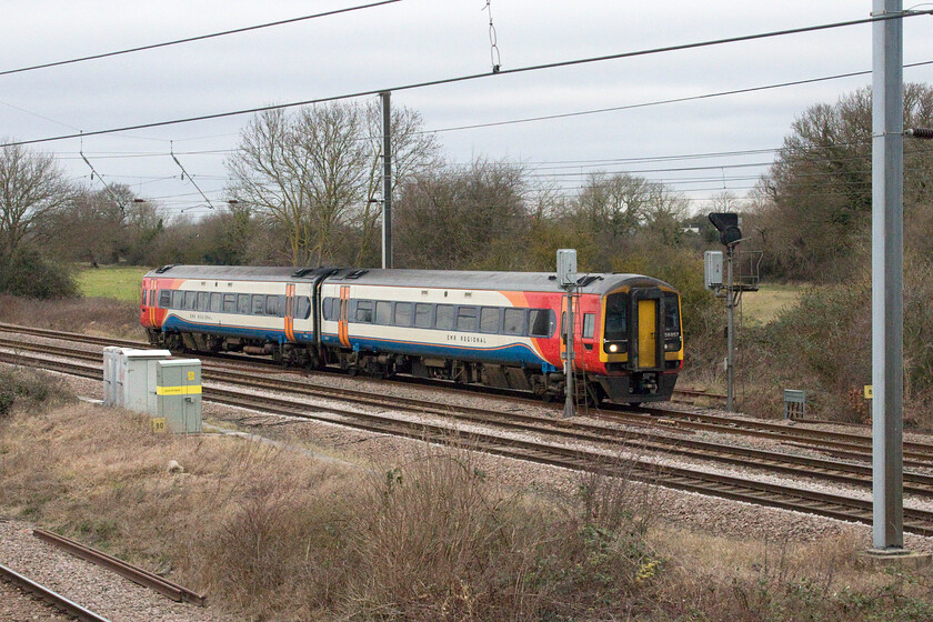 158857, 09.40 Nottingham-Norwich (1L06, 2L), Marholm TF154036 
 EMR's 158857 heads south towards Peterborough working the 09.40 Nottingham to Norwich service. EMR split its inter-regional services last year rather than running through services between Liverpool and Norwich. They now start and terminate at Nottingham; something that has not gone down well with everybody! 
 Keywords: 158857 09.40 Nottingham-Norwich 1L06 Marholm TF154036 East Midlands Railway Regional