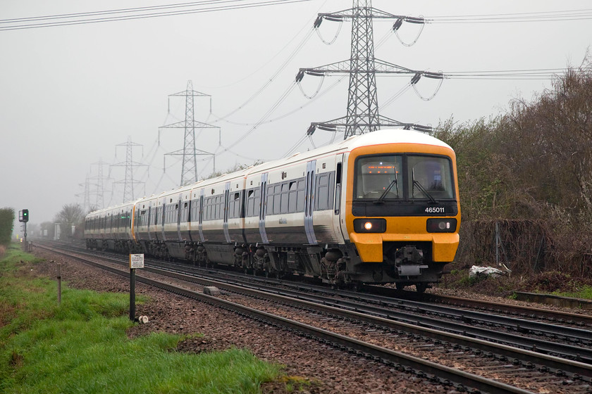 465011 & 465042, SE 07.12 London Charing Cross-Gilligham (2L14, RT), Hoo Junction TQ694736 
 In very grey conditions down on Shorne Marshes at the very mouth of the Thames, 465011 and 465042 pass with the 07.12 Charing Cross to Gillingham working. This site is actually at Hoo Junction and is taken from a public crossing. I apologise for the electricity pylons growing out of the roof of the Newtworkers! 
 Keywords: 465011 465042 2L14 Hoo Junction TQ694736