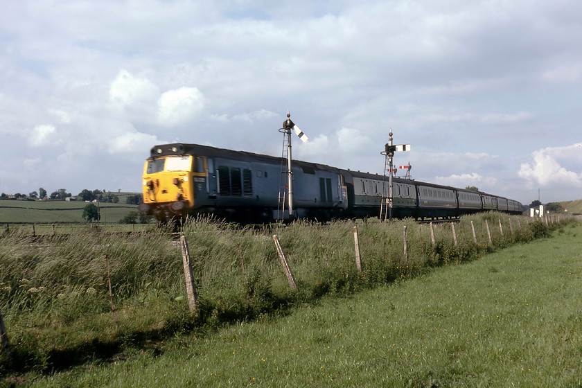 50030, 14.25 London Paddington-Plymouth (1B02), Hele & Bradninch 
 Unfortunately, a photograph marred somewhat by some motion blur caused by the camera's limitation by having a relatively slow maximum shutter speed of 1:500/sec. 50030 'Repulse' is seen charging down from Whiteball summit leading the 14.25 Paddington to Plymouth on the approach to Hele and Bradninch. At this time, Hele and Bradninch still had an up and down loop just north of the station as can be seen from the two extra signal arms, a pair of stand-alones (for the down) and the other as a doll on a bracket (for the up).

There is an audio recording of this event on my youtube channel, see..https://youtu.be/FBH9R3N8XNo 
 Keywords: 50030 14.25 London Paddington-Plymouth 1B02 Hele & Bradninch Repulse